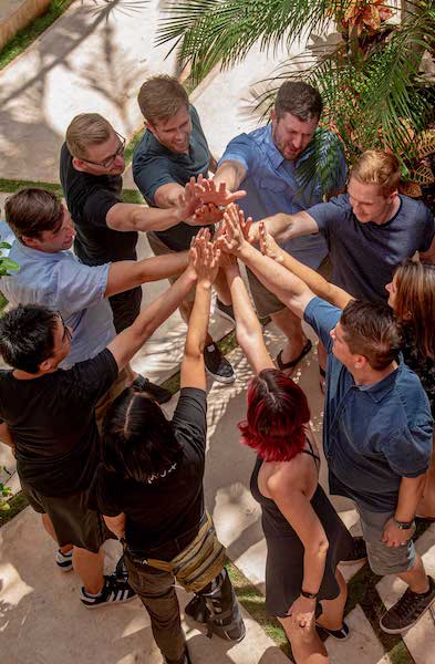 Several people high-fiving each other.