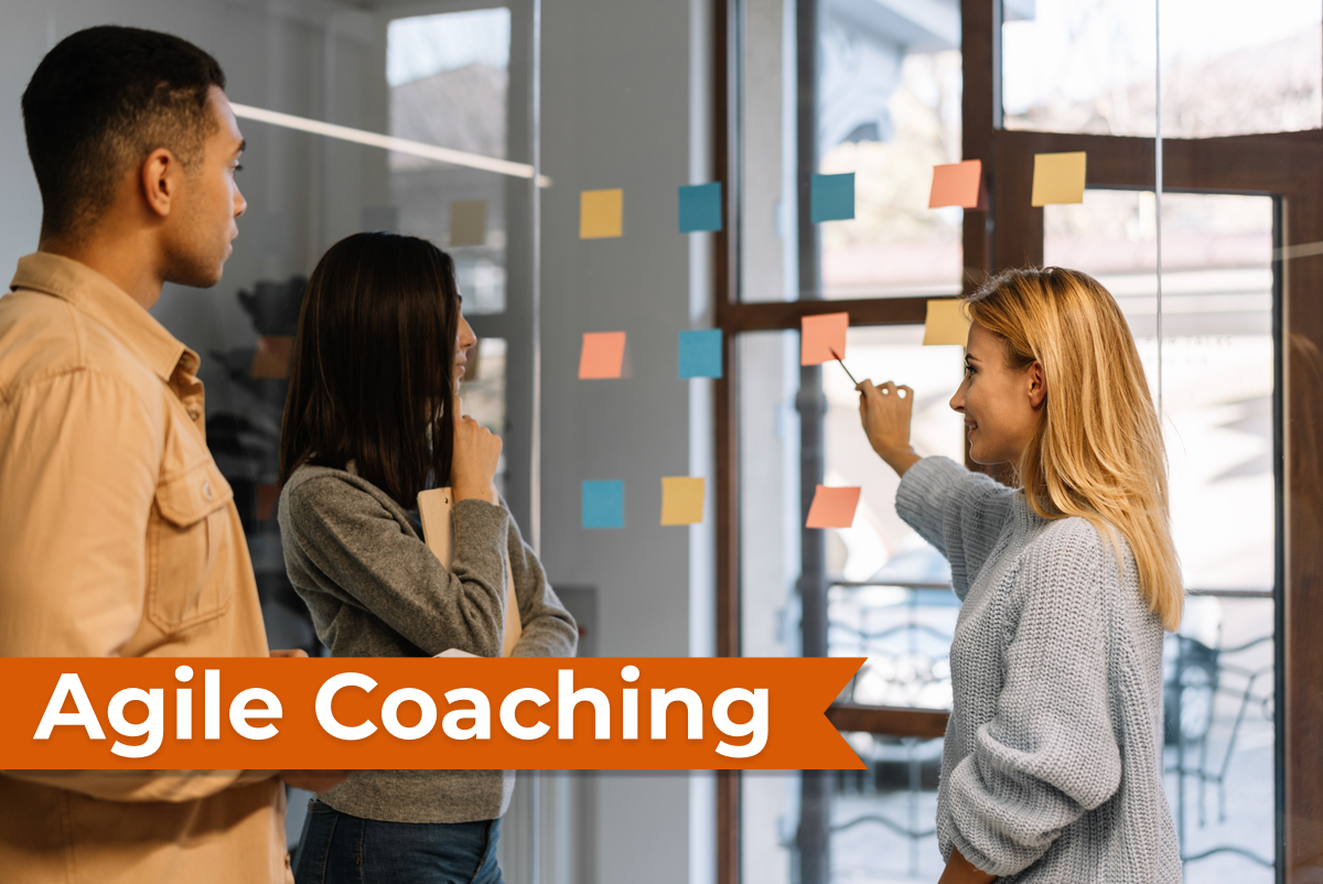 Three people collaborating around a glass disc with post-it notes.